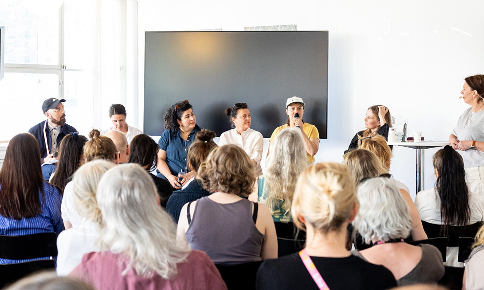 A group of people speaking at a seminar